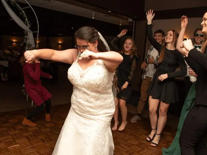 Bride dancing with guests at the wedding reception