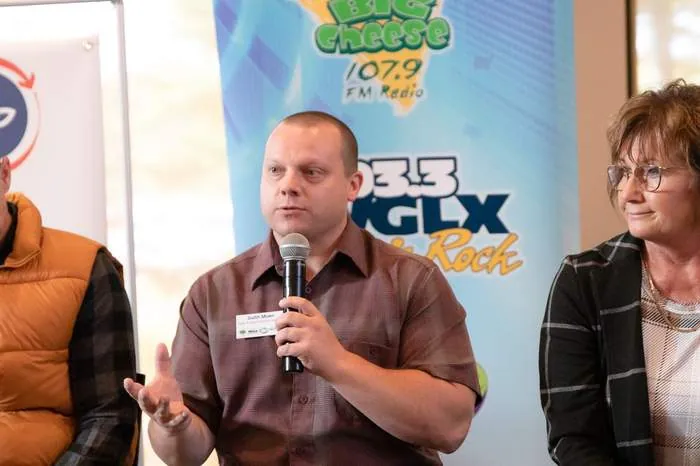 Panelist speaking into a microphone at a business event