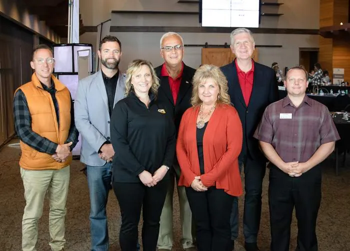 Business leaders posing together at a community leadership event