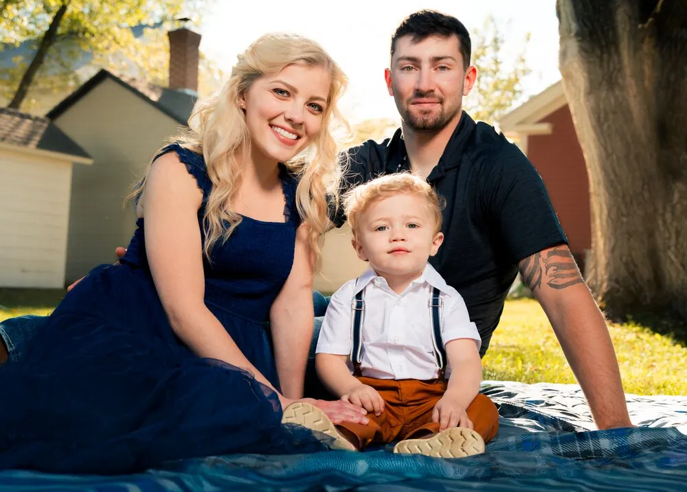 Family portrait with toddler on a picnic blanket