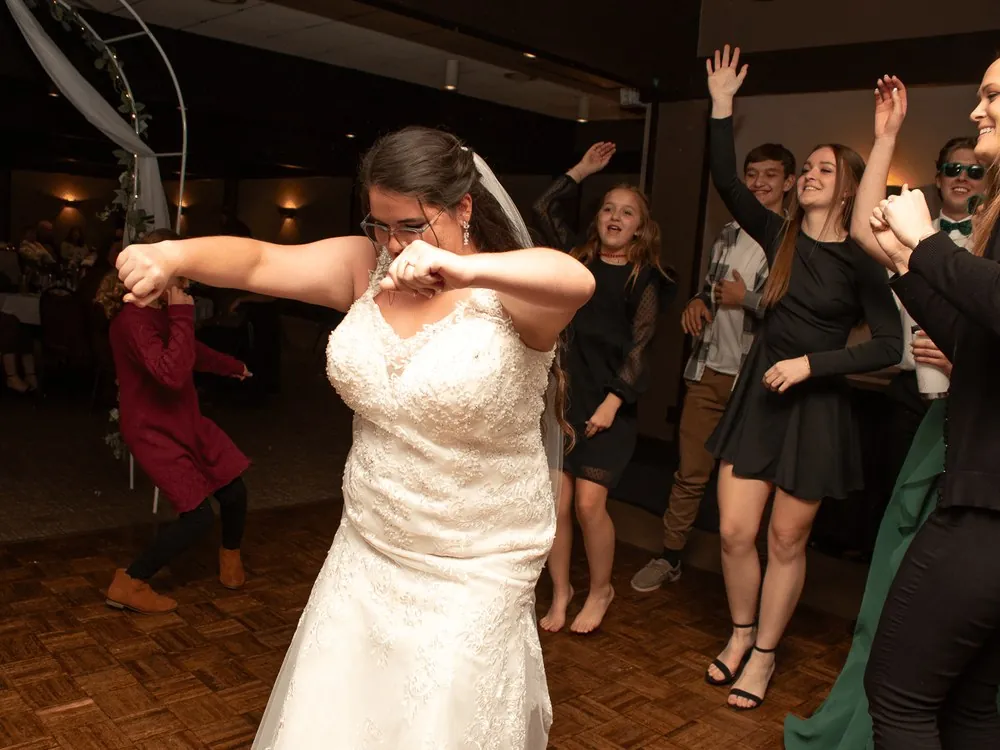 Bride dancing with guests at the wedding reception